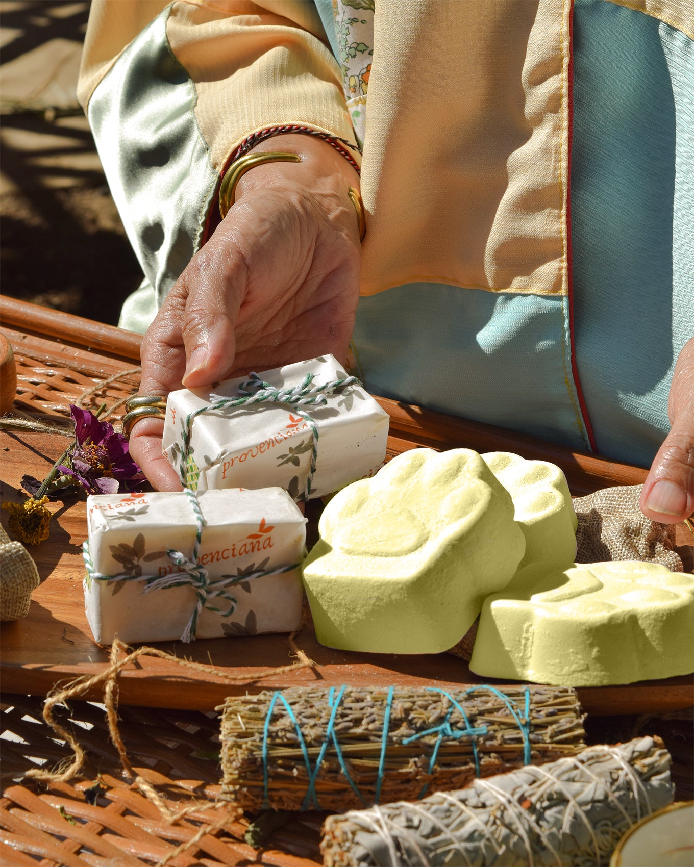 A close-up of the Dymka Pet Soap bar held in hand, showing the natural, textured finish of the plant-based formula.