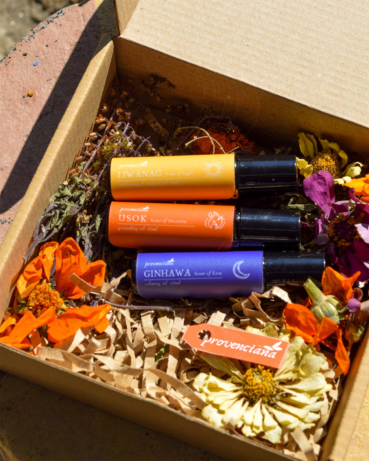 Three Provenciana Halimuyak ritual oil rollers—Liwanag, Usok, and Ginhawa—nestled in a sustainable kraft box with dried flowers and a branded tag.